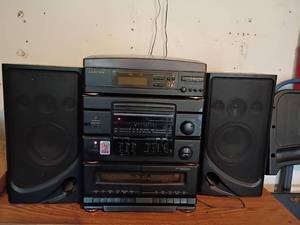 lot 2411 image: Lloyds Compact Music System.   Radio Works. Didnt try anything else.  15 x 11 x 12.   Speakers 13.5 x 7 x 5