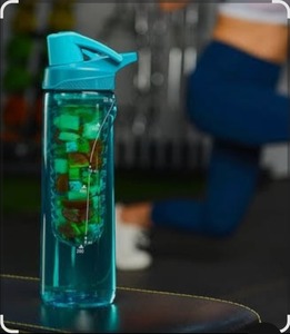 lot 6331 image: Star Trine fruit infuser water bottle, which is a reusable plastic bottle designed to hold fruit in a central chamber to flavor the water. 24 OZ