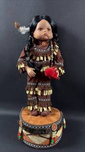 lot 12 image: GOLDENVALE NATIVE AMERICAN PORCELAIN DOLL ON DRUM