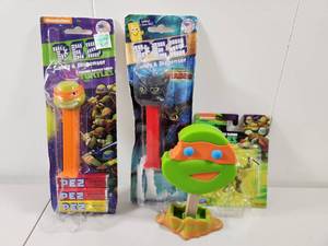 lot 165 image: Teenage Mutant Ninja Turtles PEZ Dispensers and Action Figure Set