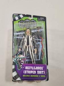 lot 221 image: NECA Beetlejuice Striped Suit Action Figure with Handbook and Snake