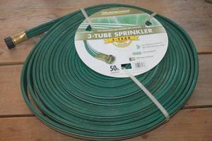 lot 4833 image: NIP 50 foot Sprinkler Hose