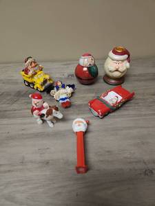 lot 410 image: Small Santa Items Collection including a candle holder and toys (the wind up santa on the horse works)
