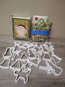 lot 435 image: Christmas Cookie Cutters Set a box of SantaHo-Ho-Ho Greeting Cards, and 3 sets of new in package holiday paper napkins