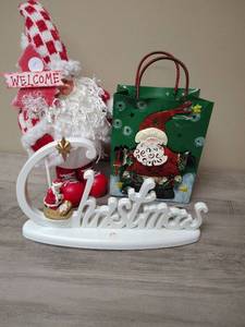 lot 436 image: Christmas Holiday Decoration Bundle with Santa Figure, Christmas Table Top Sign, and Metal Gift Bag