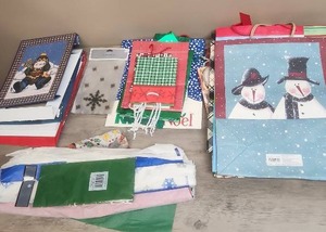 lot 487 image: Christmas Holiday Gift Bags and Wrapping Paper Collection- roughly 18 bags, 5 boxes, treat bags and tissue paper.