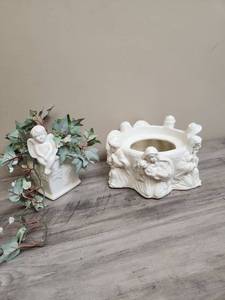 lot 502 image: White Ceramic Angel Candle Holder or Plant Stand and a Ceramic Angel vase with greenery
