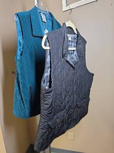 lot 1151 image: Two womens size XL Quilted vests - Black Christopher Banks with plaid lining, and Emerald Green from Alison Daley (looks blue in photos)