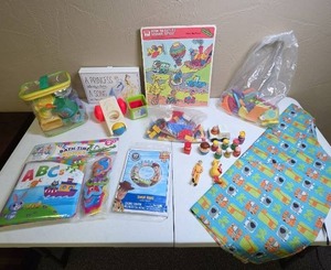 lot 1300 image: Vintage and modern toys mostly for toddlers, kids aprin, fisher price little people, puzzle, Disney princess wall art, toy story swim ring, Legos, toddler bath time baby book new in package