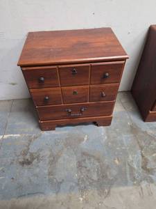 lot 17 image: Wood laminate night stand.  Matches the one in lot 18 and the dresser in lot 19. Some scratches on the top. 23W x 15.75D x 26H