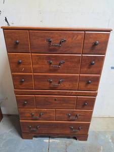 lot 19 image: Wood Laminate 5-Drawer Chest of Drawers with Black hardware. Has a few spots of wear and chips in the laminate. 34.25W x 15.75D x 54H. Matches night stands in lots 17 and 18