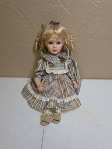 lot 282 image: Porcelain Girl Doll with Blonde Curly Hair and Striped Dress