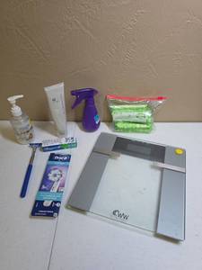lot 1206 image: Weight Watchers Digital Bathroom Scale, Water Spray Bottle, partial used tube of NuSkin Agelock Dermatic Effects, bag of tampons