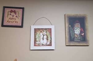 lot 448 image: Christmas Wall Art - Canvas Santa with Tree, Snowman with White Metal Frame, and Fabric Merry Christmas with black frame