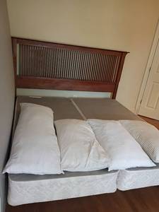 lot 921 image: King Sized Bed.  Headboard, Box Springs, 3 King Size Bed Pillows and a Body Pillow. Headboard 54 x 87 x 4.5.  Matches lots 922 and 923