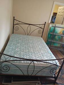 lot 925 image: Full Sized Bed with Metal Frame.  Comes with a mattress and box spring.  Headboard 50 x 54