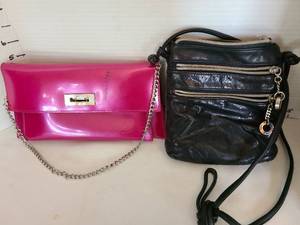 lot 1062 image: Perlina black purse and Beijo fushsia purse has stain on front
