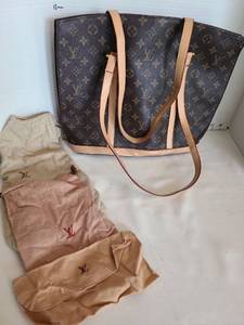lot 1063 image: Louis Vuitton purse and felt bags. A portion of the lining needs resewn under zipper