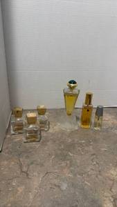 lot 1462 image: Jivago 24K womens perfume spray featuring a conical bottle on a frosted base, empty bottles of Grand Soir along with other perfume