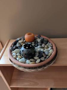 lot 31 image: Terra Cotta Bowl with River Rocks and Star Pattern Tea Light Holder