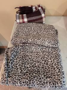 lot 95 image: Two leopard print throws in one plaid throw