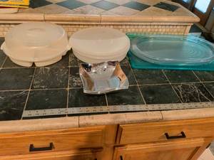 lot 202 image: Makes a lot of three serving trays Tupperware container with lid veggie container with lid and three silver plastic serving dishes