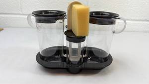 lot 57 image: Plastic Coffee Mug Set with Black Lids and Caddy Holder