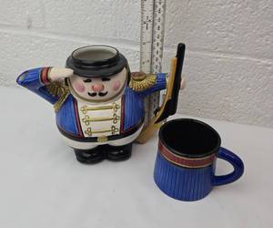 lot 106 image: Fitz and Floyd Nutcracker Soldier Teapot with Matching Mug Set