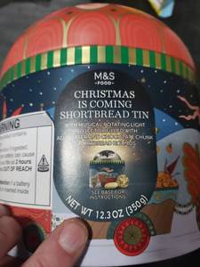 lot 7362 image: M&S Christmas Shortbread Tin with Musical Light Projector
