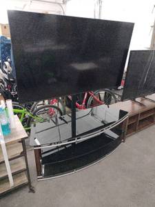 lot 20668 image: black and silver metal TV stand with curved tempered glass shelves (TV Not Included)