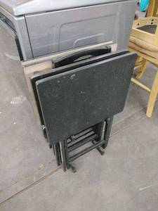 lot 20933 image: 5-piece set of black folding TV tray tables with a matching storage stand