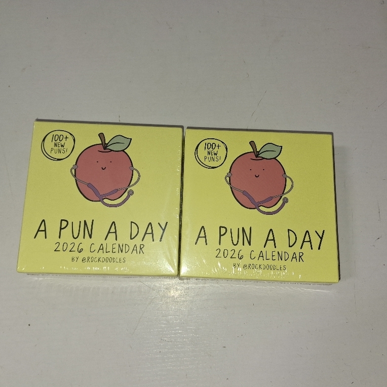 lot 3570 image: LOT OF TWO - Rockdoodles 2026 Punny Day-to-Day Calendar  Funny Daily Desktop Calendar Christmas Stocking Stuffer Gift for Home or Office, Daily Tear Off Pages With New Puns  A Pun A Day by Rockdoodles