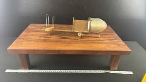 lot 40581 image: Vintage stereoscope  Design Features a folding wooden handle and a metal hood with lenses.
