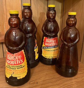 lot 48 image: Vintage Mrs. Butterworths Amber Glass Bottle Collection