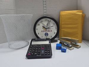 lot 348 image: Air Force Clock United States Air Force wall clock that plays Reveille.  Featuring the official logo and eagle emblem.  With mixed Office Supply Lot
