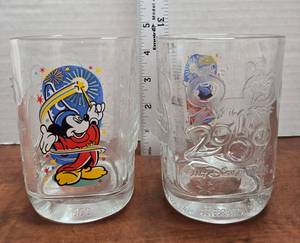lot 379 image: 2000 Walt Disney World McDonalds Mickey Mouse Glass, part of a promotional set commemorating the millennium celebration. Design Features Sorcerer Mickey from Fantasia waving a magic wand with fireworks and stars.