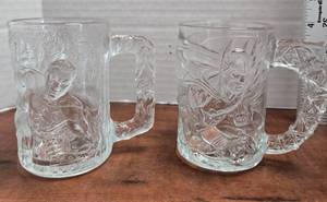 lot 381 image: Vintage 1995 McDonalds Batman Forever Batman and Robin glass mugs. Design The 2 mugs feature a 3D embossed image of 1) Batman and 2) Robin from the 1995 film Batman Forever.