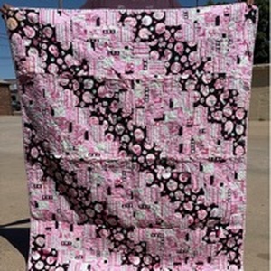 lot 108 image: Pink and Black Crib Quilt