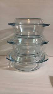 lot 146 image: Graduated Casseroles with Glass Lids That invert for Stacking. Perfect for Baking, Roasting and Food Storage Largest has an 8.5 Diameter Mouth