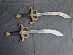 lot 1549 image: Ornate Middle Eastern Curved Dagger Set with Decorative Brass Guards - 2 ct