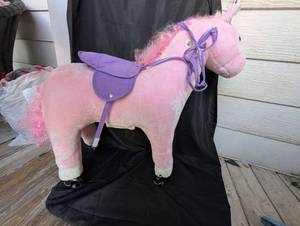 lot 4000 image: Pink Unicorn Ride-On Toy with Purple Saddle and Wheels