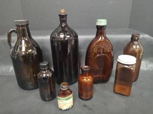 lot 391 image: Vintage Brown Glass Bottles, Lysol, Clorox and More