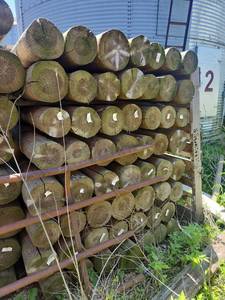 lot 10380 image: Pressure Treated Wooden Posts and Lumber Bundle - Lot of 56