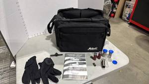lot 1017 image: Michaels of Oregon hand gun bag with gloves, Beretta manual and choke tubes