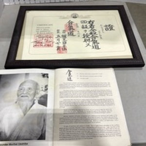 lot 1040 image: Aikoido framed certificate and booklet 15.5x20