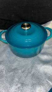 lot 7 image: Tramontina Teal Cast Iron Dutch Oven with Stainless Steel Knob