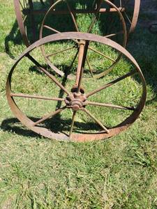 lot 20864 image: Cast Iron Wagon Wheel Set with Spoked Design 24inL - Retail $75