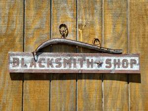 lot 20872 image: Blacksmith Shop Wooden Sign with Metal Hardware 39.5 in across  - Retail $75