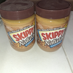 lot 8207 image: 2 Jars SKIPPY Natural Creamy Peanut Butter Spread, 7 g Protein Per Serving, 26.5 oz Jar