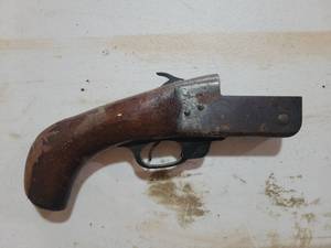lot 52 image: Wall hangers  wooden stock and metal barrel. Features traditional hammer mechanism and curved grip design. Shows signs of age and use throughout
